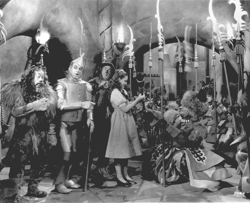 Judy Garland, as Dorothy in “The Wizard of Oz,” is presented with the Witch’s broom in a scene from the 1939 movie. Garland is accompanied by, from left to right, Bert Lahr as the Cowardly Lion, Jack Haley as the Tin Man, and Ray Bolger as the Scarecrow. (Associated Press)
