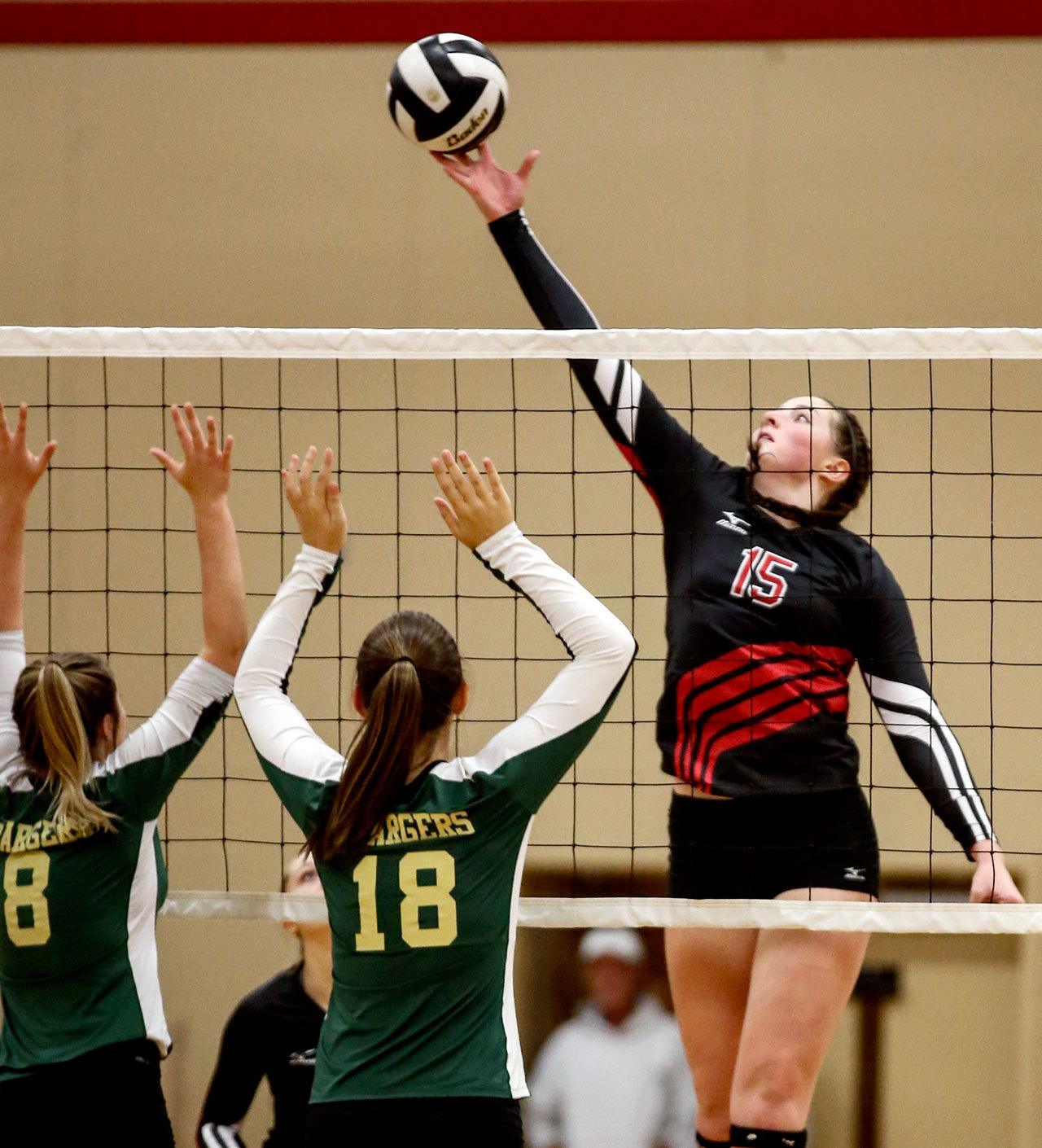 Snohomish’s Rosamund Gillie attempts a kill past Marysville Getchell’s Alison Sievers, left, and Meghan Barger Thursday night during the Panthers’ straight-set victory over the Chargers on Thursday in Snohomish. (Kevin Clark/The Herald)