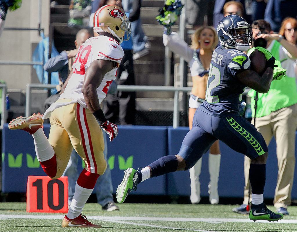 Seahawks running back Christine Michael eyes 49ers safety Jaquiski Tartt, left, on his way to the end zone for the touchdown Sunday afternoon at Century Link Field in Seattle on September 25, 2016. The Seahawks are 2-1 after defeating the 49ers 37-18. (Kevin Clark / The Herald)
