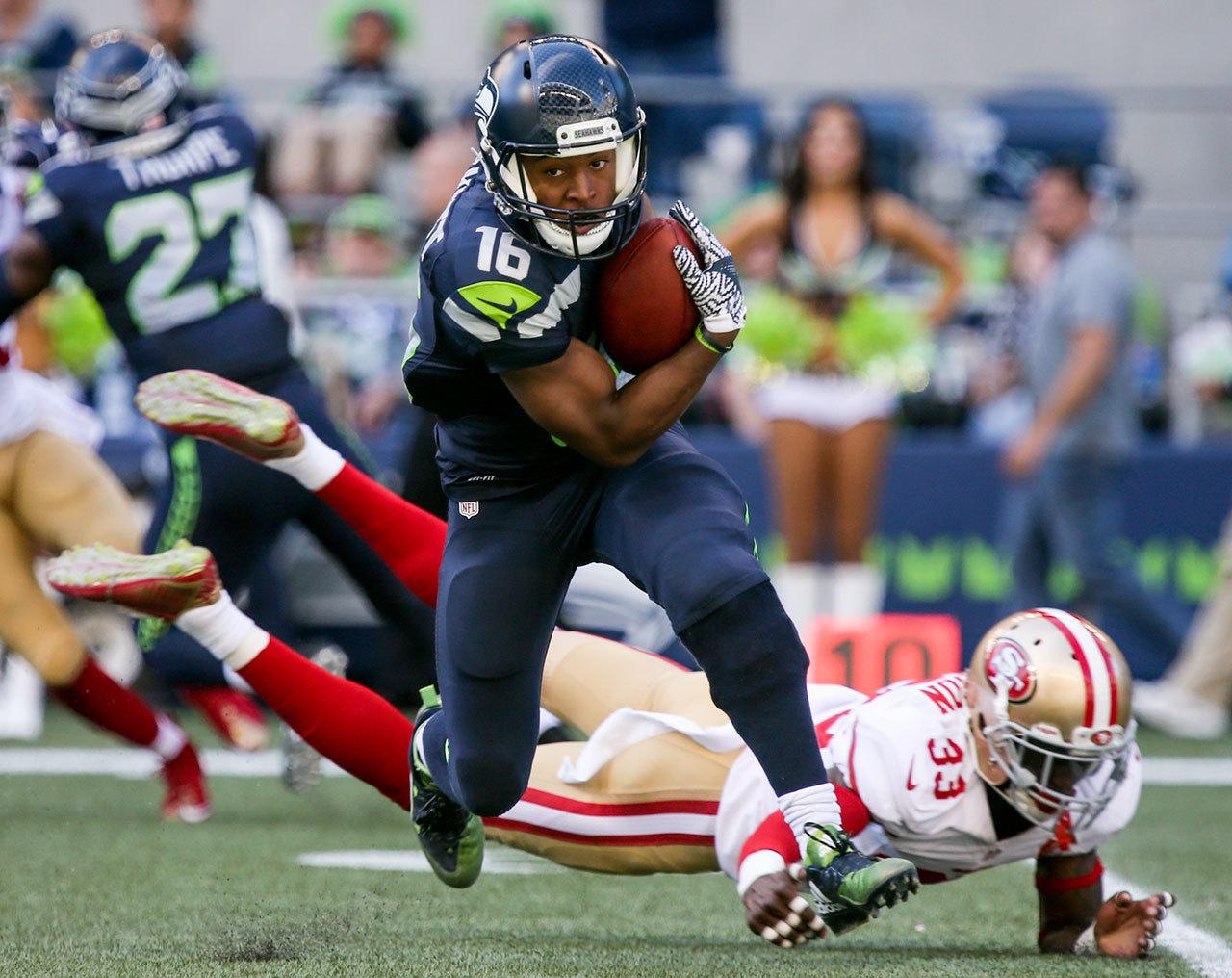 Seahawks wide receiver Tyler Lockett eludes 49ers corner back Rashard Robinson for more yards Sunday afternoon at Century Link Field in Seattle on September 25, 2016. The Seahawks are 2-1 after defeating the 49ers 37-18. (Kevin Clark / The Herald)