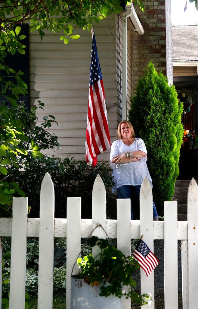 (Dan Bates / The Herald) Patricia Mackey of Edmonds put the flag up on her home on September 11, 2001 and has kept a flag there every day since. She doesn’t want people to forget.
