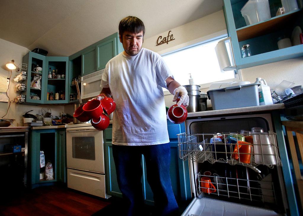 Among the various chores to do at Everett Recovery Cafe, Jance Groff likes helping in the kitchen. (Dan Bates / The Herald)
