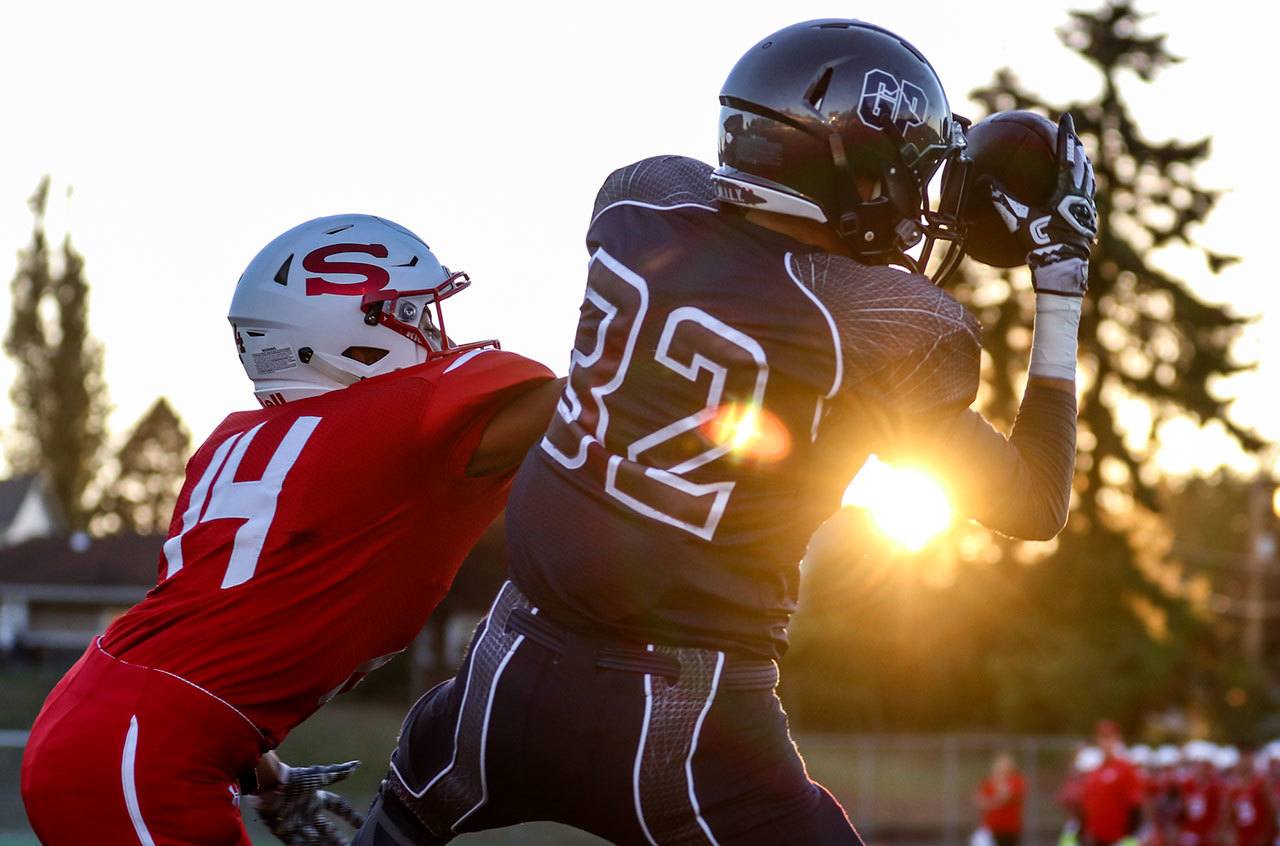 Glacier Peak’s Bo Burns makes a touchdown reception with Snohomish’s Kevin Lopez defending Friday night at Veterans Memorial Stadium in Snohomish. (Kevin Clark / The Herald)