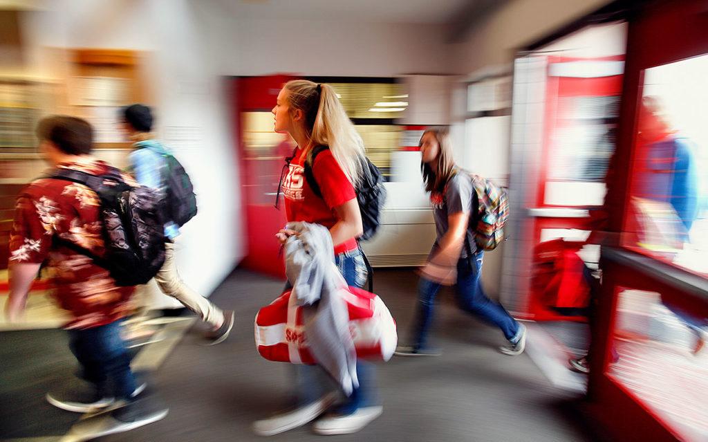 Because of the sprawling Stanwood High campus, students move quickly through crowded hallways and common areas, carrying backpacks and duffle bags between classes. (Dan Bates / The Herald)
