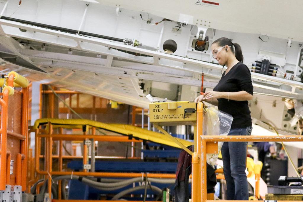 An assembly worker checks out a wing of the 500th 787 Dreamliner at the assembly plant in Everett. Air France is slated to receive the 500th 787. (Kevin Clark / The Herald)
