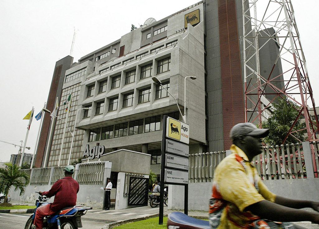 In this 2006 file photo, motorbike riders drive pass the Agip oil company head office building in Lagos, Nigeria. (AP Photo/George Osodi, File)
