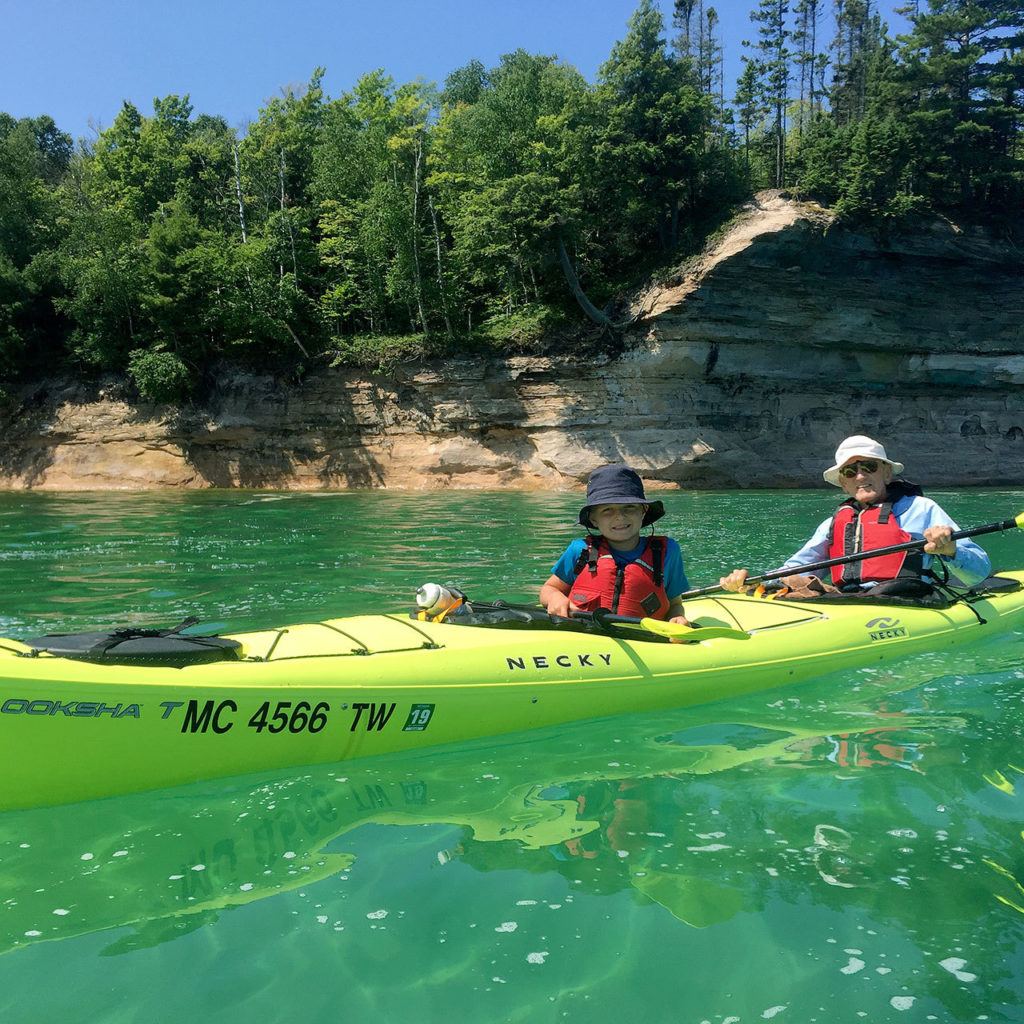 Oliver Welcker kayaks with his Grandpa, Dick Hanson of Bloomington, Illinois, at Pictured Rocks National Lakeshore in Munising, Michigan. (Maureen Welcker)
