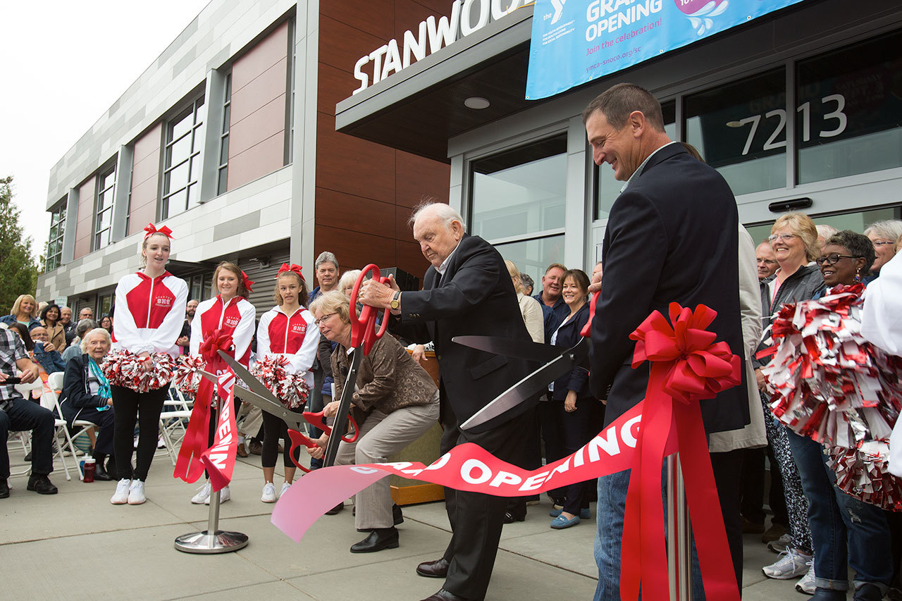 Floyd Jones (center) helps cut the ribbon at the Grand Opening on the Stanwood-Camano YMCA on Sept. 3 in Stanwood. Jones, a Seattle stockbroker and philanthropist with a home on Camano Island, donated $10 million through the Floyd & Delores Jones Foundation to the construction of the new YMCA. (Andy Bronson / The Herald)
