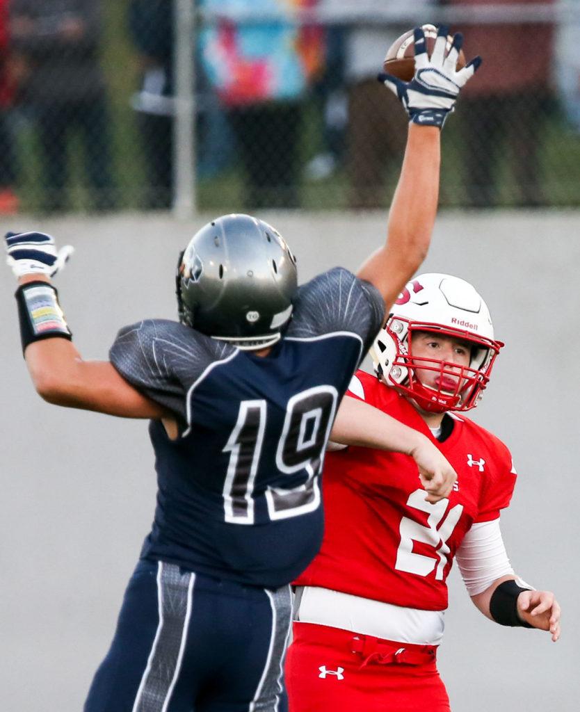 Glacier Peak’s Joshua Erling bats down a pass attempt by Snohomish’s Brandon Jodock during a game Friday night at Veterans Memorial Stadium in Snohomish. (Kevin Clark / The Herald)
