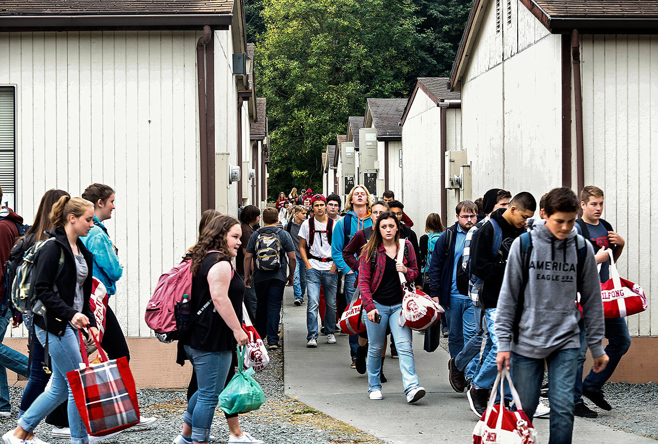 Students and faculty pour out from the many portable classrooms that are used to handle the classes for which there is not enough room in existing buildings at Stanwood High. (Dan Bates / The Herald)
