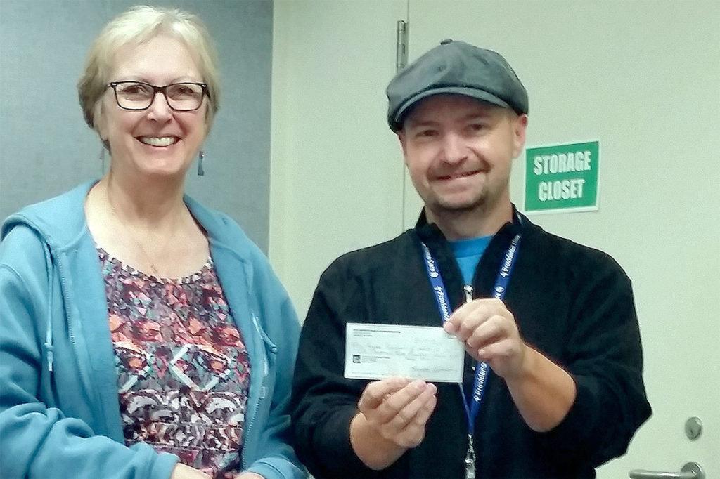 Washington Egg Artist Guild Show director Lynda Matson (left) presents Chris Robinson, annual giving manager for Providence Hospice and Home Care of Snohomish County, with a check for $1,355. (Contributed photo)
