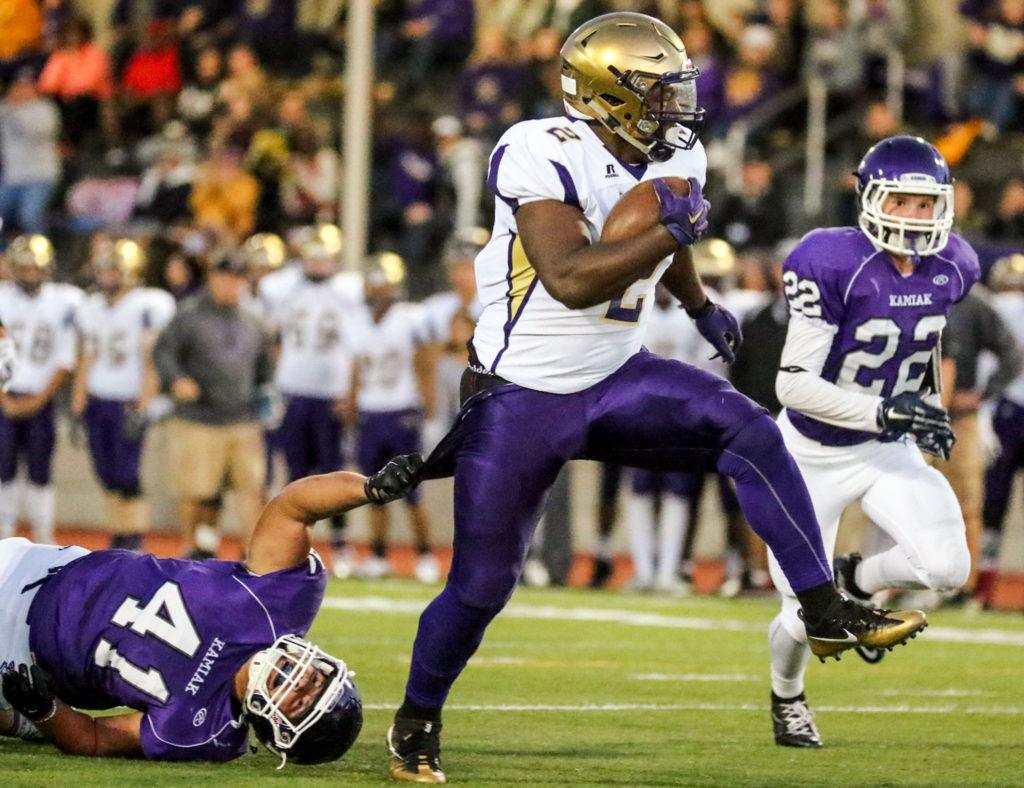 Oak Harbor’s Princeton Lollar Jr. rushes for yardage with Kamiak’s Jackson Finnerty holding on and Kamiak’s Joseph Prikhodko (right) closing in Thursday night at Goddard Stadium in Everett. (Kevin Clark / The Herald)
