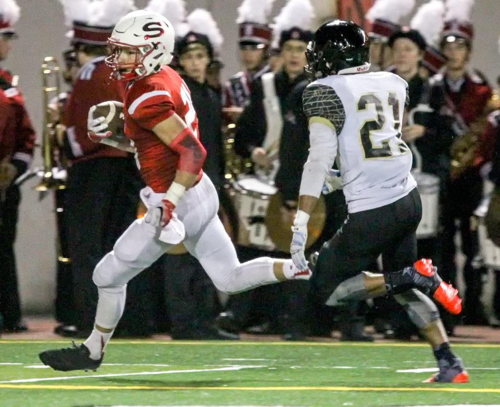 Snohomish’s Josh Johnston races for the end zone with Lynnwood’s Ryley Johnson trailing during a game Friday night at Veterans Memorial Stadium. (Kevin Clark / The Herald)
