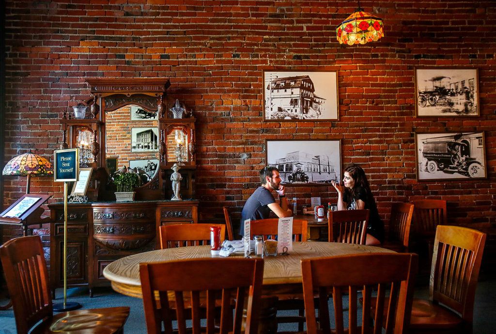 With its high brick walls, warm lighting, and friendly service, the Vintage Cafe seems a good place to relax with friends. (Dan Bates / The Herald)
