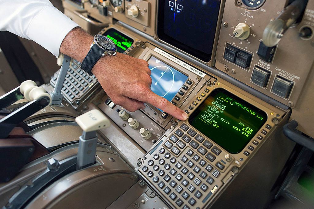UPS Capt. Christian Kast points to the Data Communications Data Comm technology in the cockpit of an UPS Boeing 767-300F aircraft at Dulles International Airport Air Traffic Control Tower in Sterling, Virginia, on Tuesday. (AP Photo/Cliff Owen)
