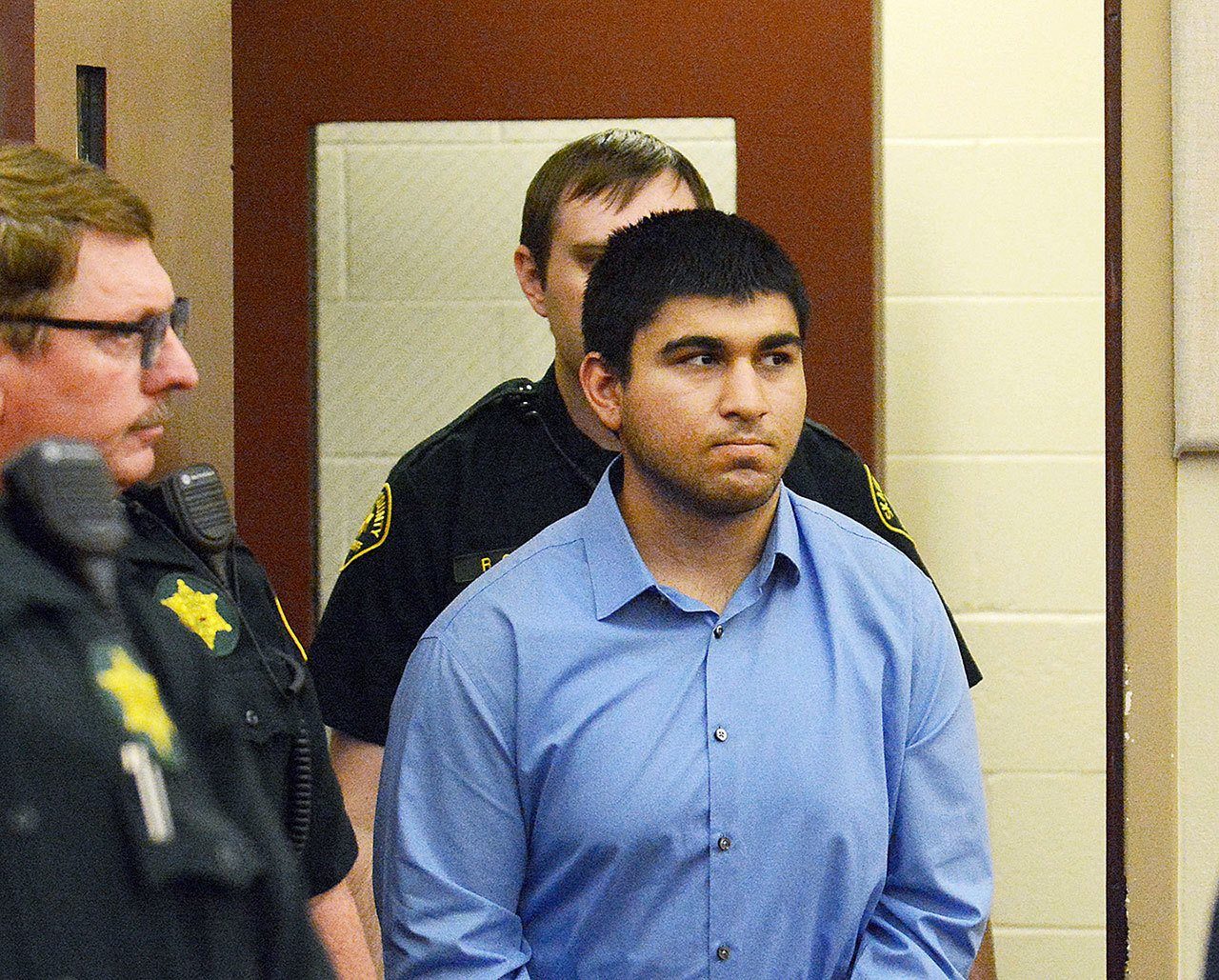 Arcan Cetin is escorted into Skagit County District Court by Skagit County’s Sheriff’s Deputies on Monday. Cetin is being held under a magistrate’s warrant which will give Skagit County prosecutors 30 days to file charges in relation to the Cascade Mall shooting that took place on Friday evening. Five people were killed in the shooting, and Cetin is being held on a $2 million bail. (Brandy Shreve/Skagit Valley Herald via AP)