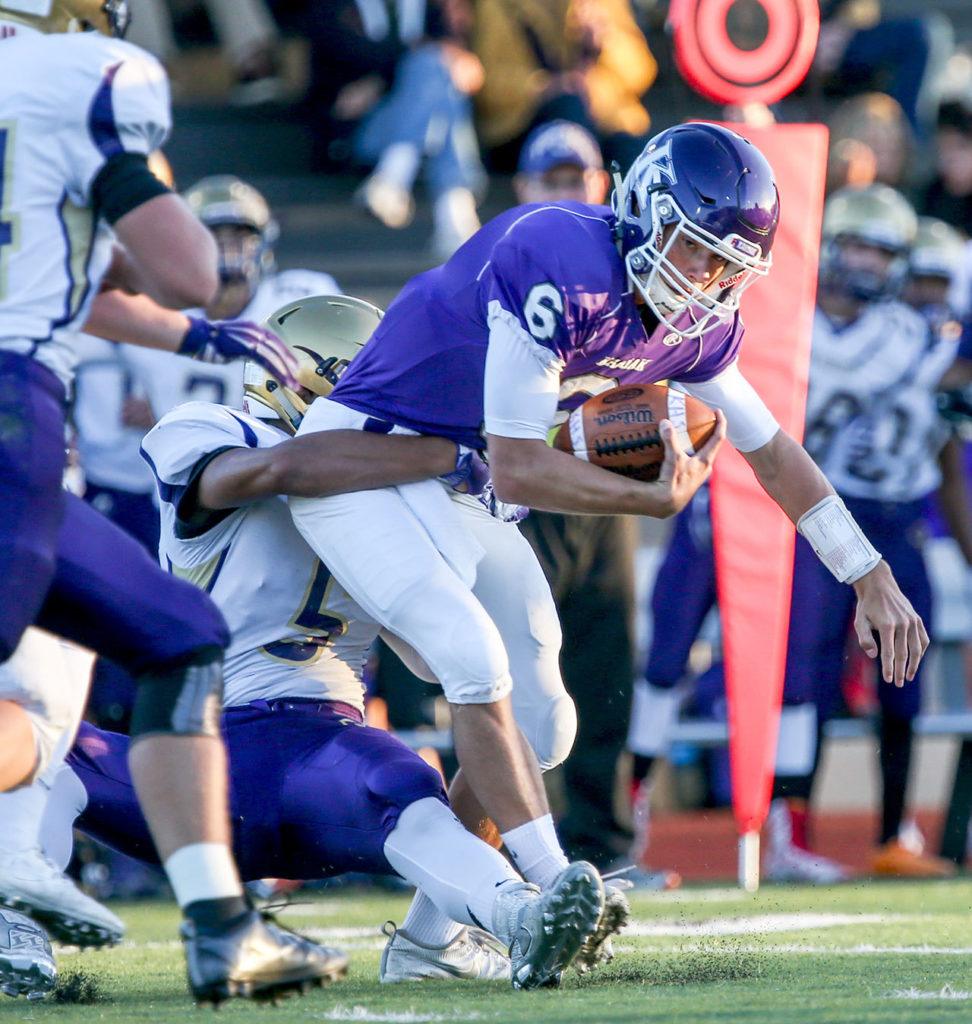 Oak Harbor’s Jordan Washington sacks Kamiak’s Matt Merk Thursday night at Goddard Stadium in Everett. (Kevin Clark / The Herald)
