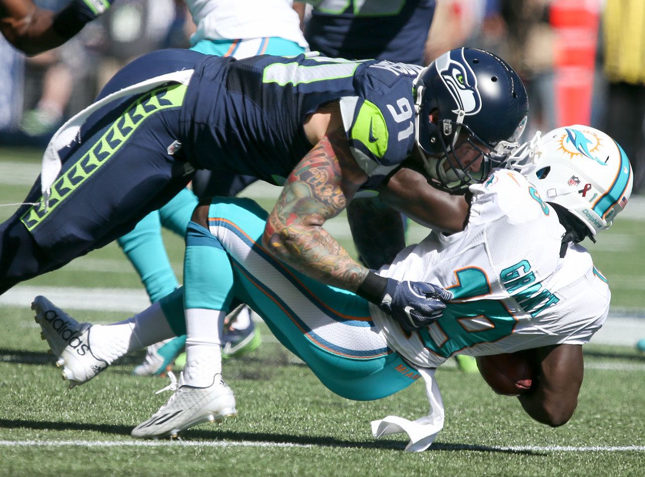 Seahawks defensive lineman Cassius Marsh tackles Dolphins wide receiver Jakeem Grant on a punt return at CenturyLink Field in Seattle on Sunday. The Seahawks defeated the Dolphins 12-10.(Kevin Clark / The Herald)