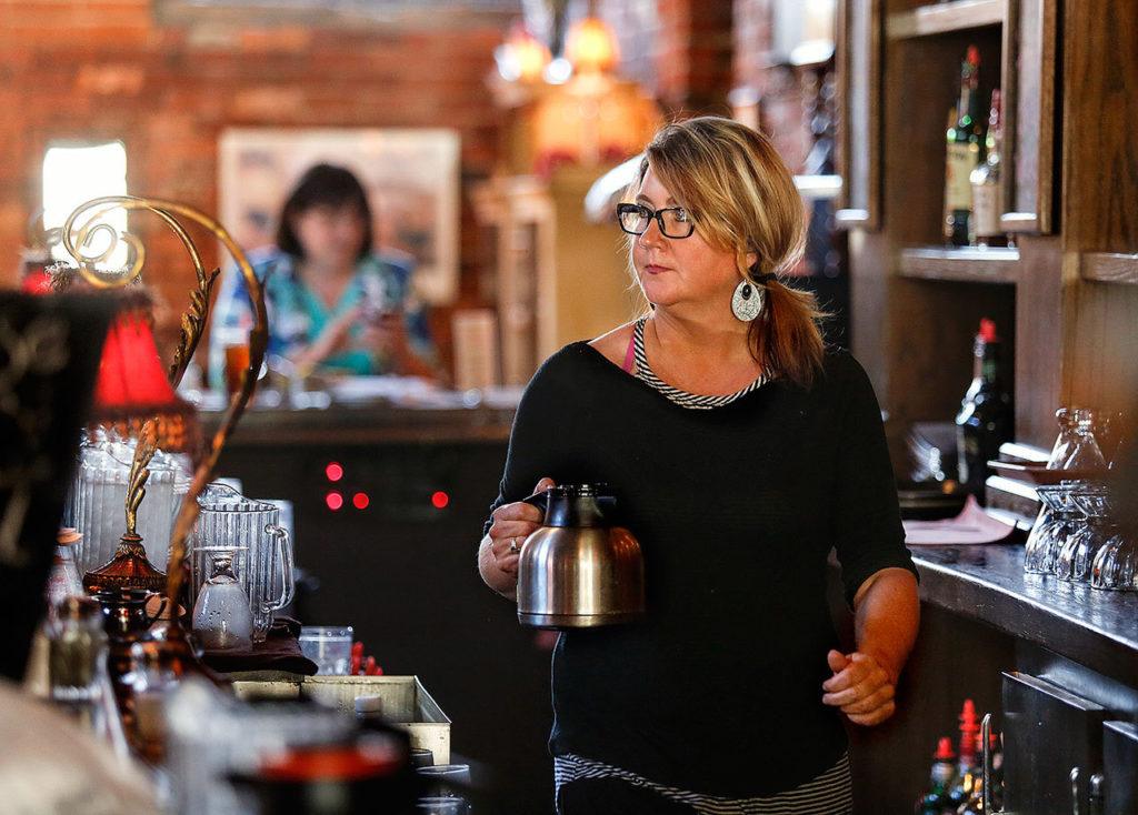 At the Vintage Cafe, Jennifer Jarvis keeps an eye out for the needs of customers, and moves quickly out to a table with fresh coffee. (Dan Bates / The Herald)
