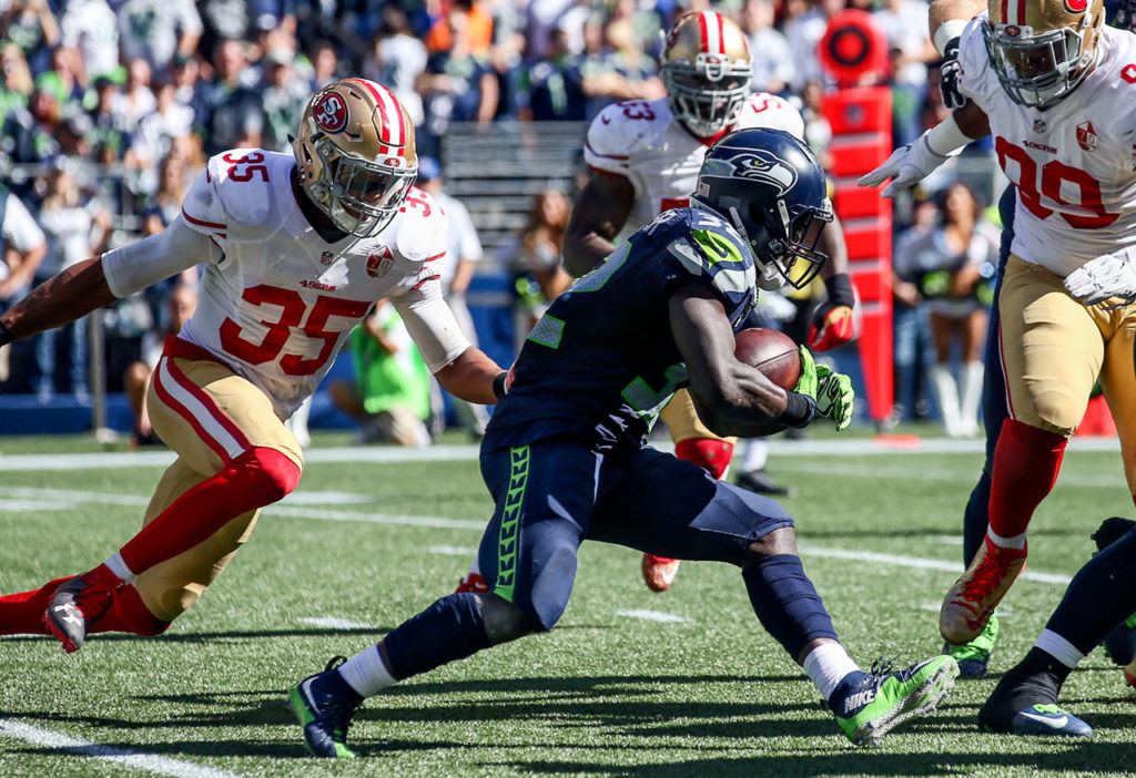 Seahawks running back Christine Michael rushes for yardage with 49er defenders closing Sunday afternoon at Century Link Field in Seattle on September 25, 2016. The Seahawks are 2-1 after defeating the 49ers 37-18. (Kevin Clark / The Herald)
