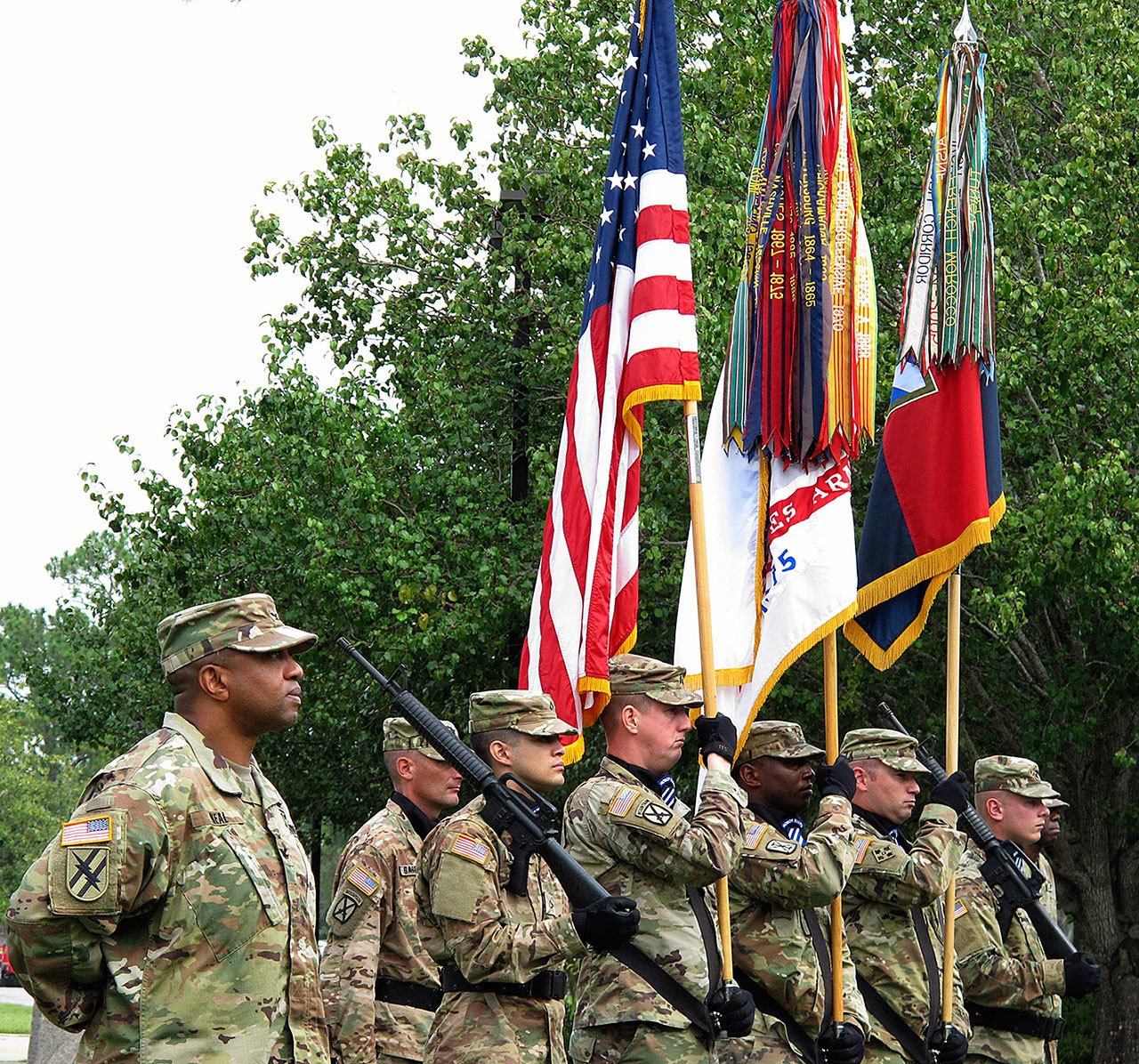 Col. Reginald Neal, far left, commander of the 48th Infantry Brigade of the Georgia National Guard, stands with an Army color guard Friday during a ceremony at Fort Stewart, Georgoa, to mark the brigade’s new alignment with the Army’s 3rd Infantry Division. The Army is pairing a dozen National Guard and Reserve units nationwide with active-duty commands, hoping to improve the combat readiness of citizen-soldiers. (AP Photo/Russ Bynum)