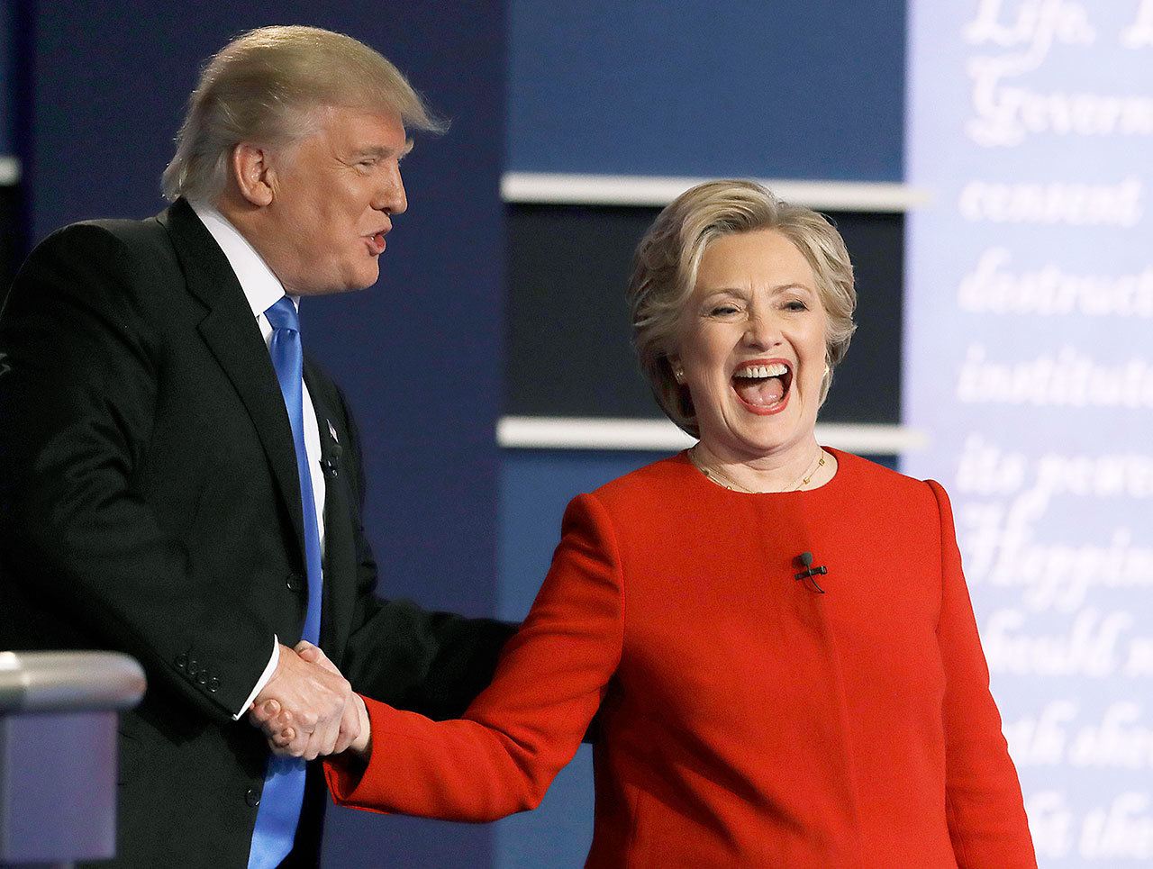Democratic presidential nominee Hillary Clinton shares a laugh with Republican presidential nominee Donald Trump following their presidential debate at Hofstra University in Hempstead, New York, on Monday. Don’t let their smiles fool you — it was an intense faceoff. (AP Photo/Julio Cortez)
