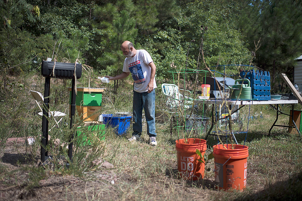 Jim Cooley feeds bees at his home in Winder, Georgia. (Washington Post/Jabin Botsford)
