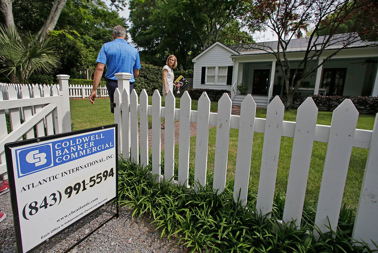 A real estate agent, right, prepares to show a home for sale in Mount Pleasant, South Carolina, in April. (AP Photo/Chuck Burton)