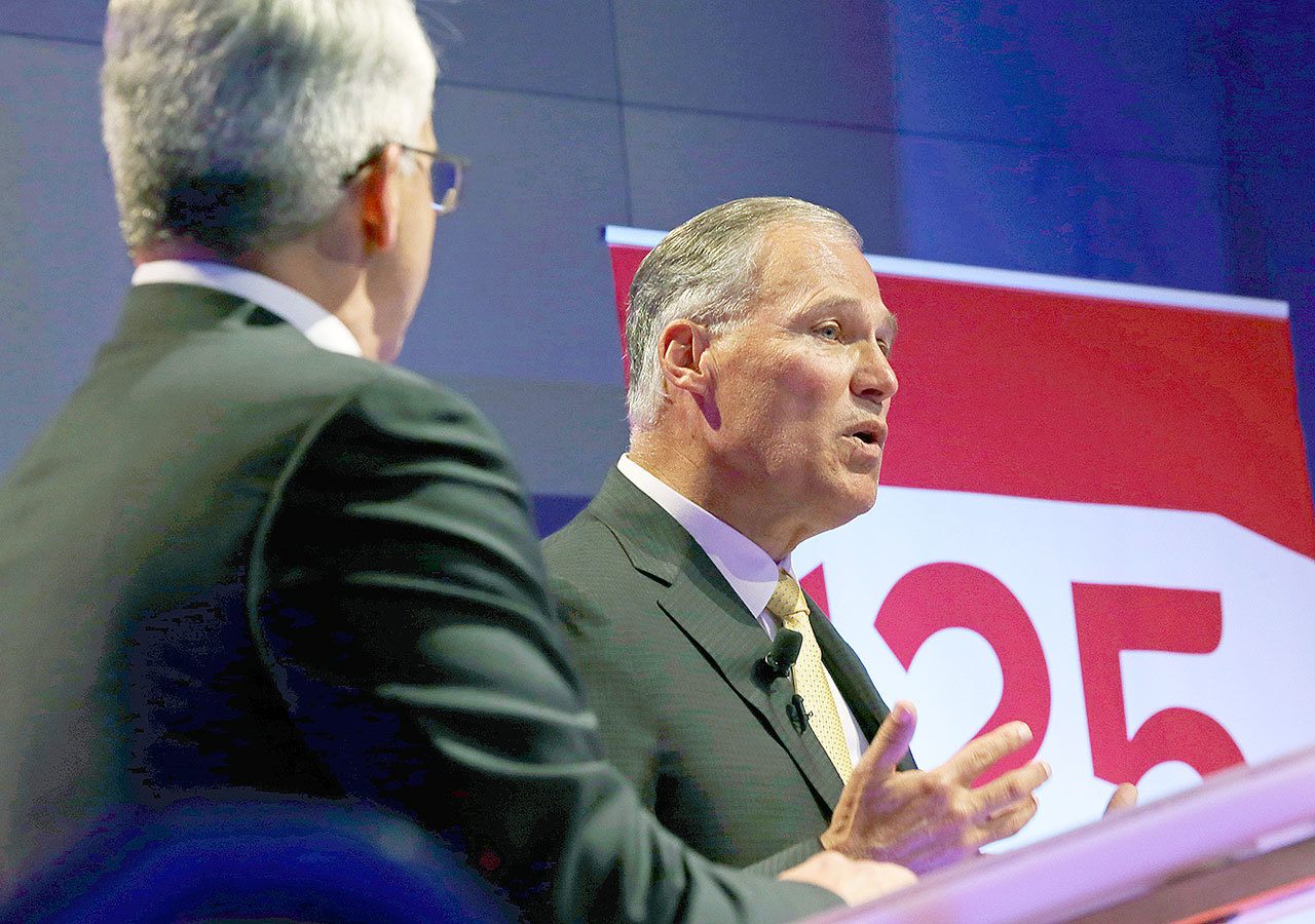 Democratic Gov. Jay Inslee (right) and his Republican challenger, Bill Bryant, take part in a debate on Monday in Seattle. (AP Photo/Ted S. Warren)