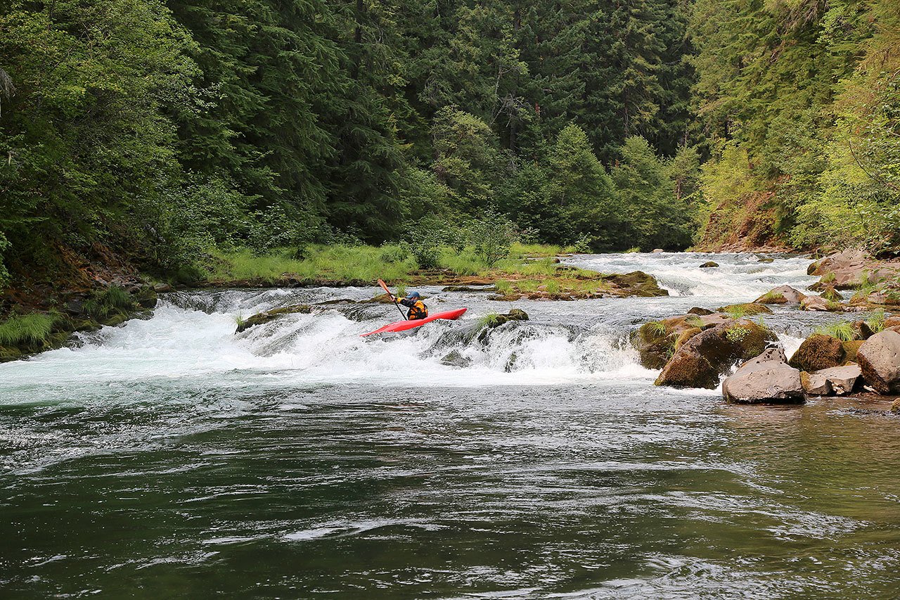 A kayaker paddles through “Right or Left” rapid on the North Fork of the Rogue River in Oregon, downstream of River Bridge Campground. (Northwest Rafting Company)