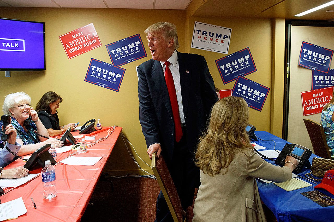 Republican presidential candidate Donald Trump visits a call center before the start of a rally Monday in Asheville, North Carolina. (AP Photo/Evan Vucci)