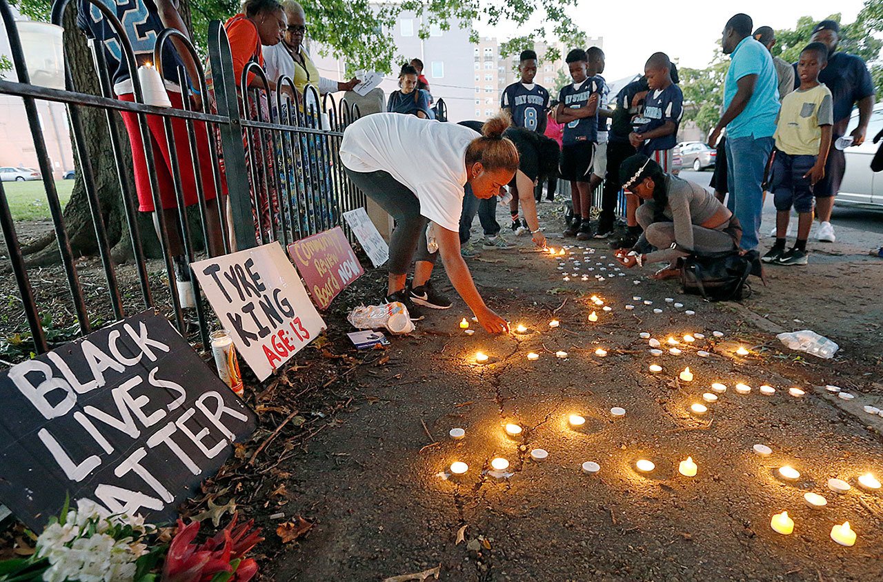 Community members light candles during a vigil for 13-year-old Tyre King on Thursday in Columbus, Ohio. King was shot and killed by Columbus police Wednesday evening. (AP Photo/Jay LaPrete)