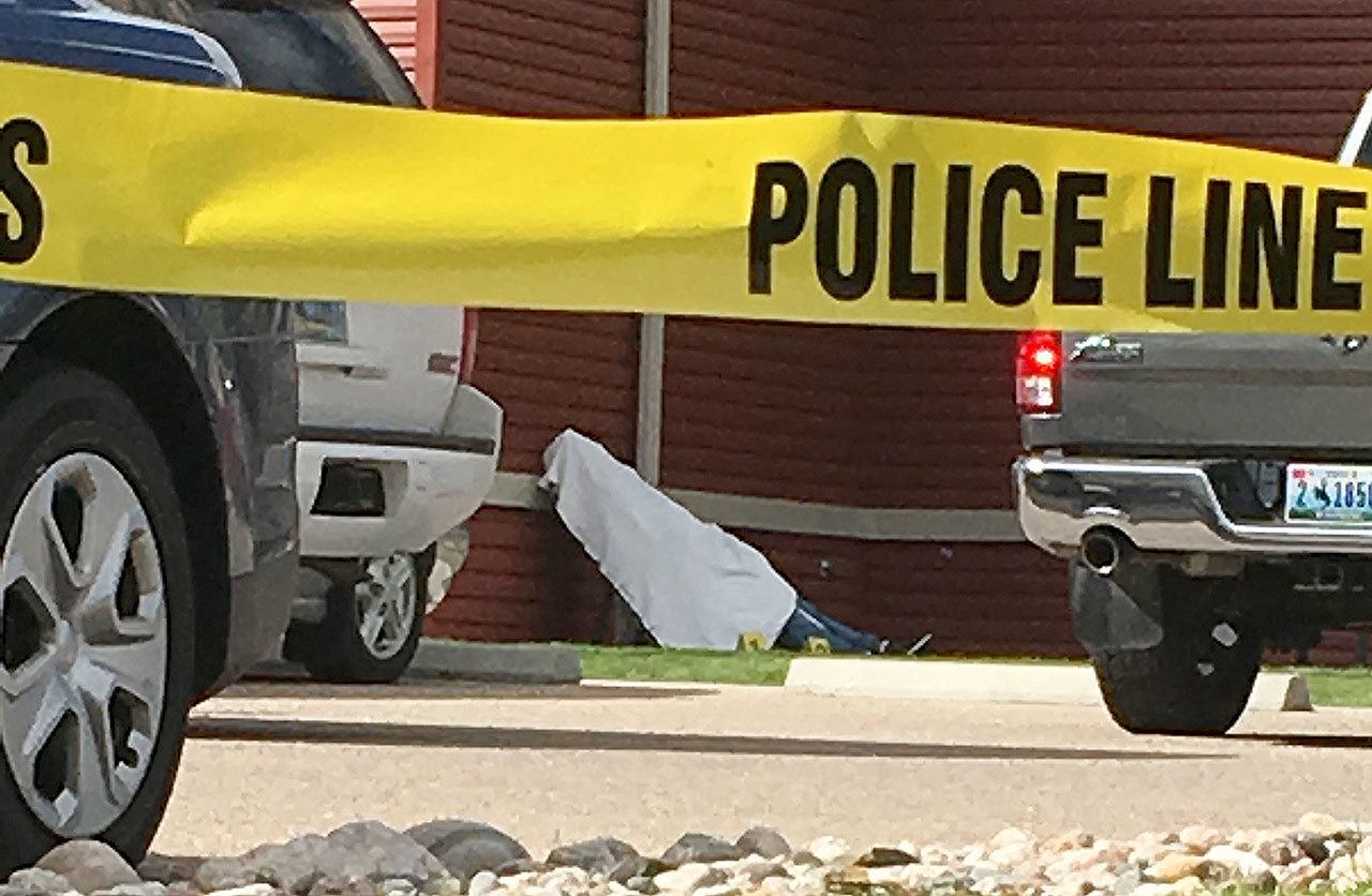 A man killed by a shooter at a senior citizen apartment is covered by a sheet on a stretcher Wednesday in Cheyenne, Wyoming. A 77-year-old man living at the senior citizen apartment complex shot three people at the complex, killing one of them, and then killed himself nearby as officers closed in on him. (AP Photo/Mead Gruver)