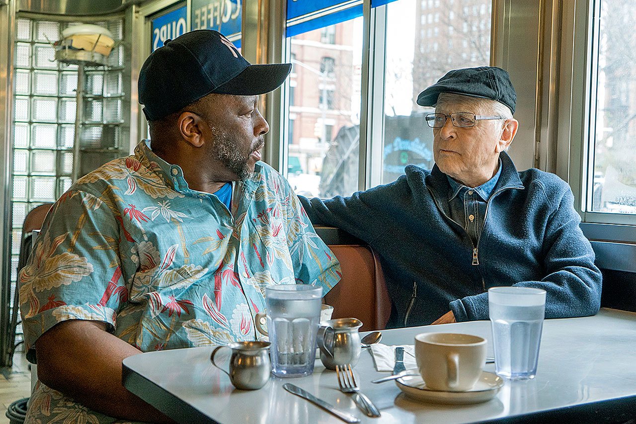 Rob Robinson (left) talkes with with producer Norman Lear in a scene from the documentary “America Divided.” The five-week eries premieres Friday at 9 p.m. on Epix. (Nicole Rivelli/Epix )