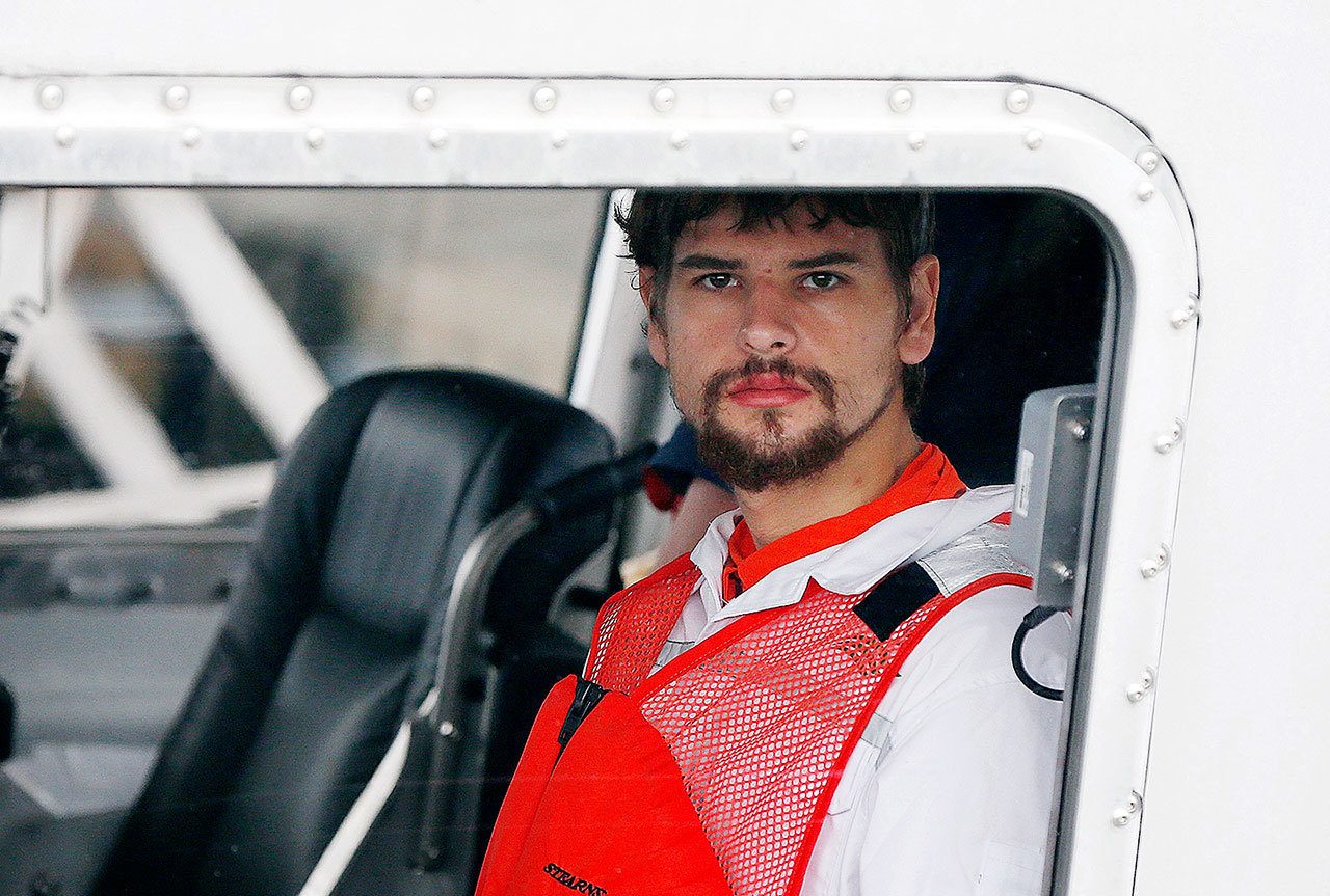 Nathan Carman arrives in a small boat at the US Coast Guard station in Boston, on Tuesday. Carman spent a week at sea in a life raft before being rescued by a passing freighter. (AP Photo/Michael Dwyer)