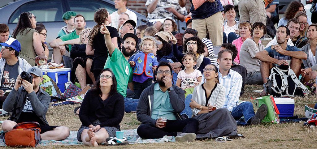 Scores of people gather to watch Vaux’s Swifts swarm to roost for the night inside a large, brick chimney at Chapman Elementary School in Portland, Oregon, on Friday. (AP Photo/Don Ryan)
