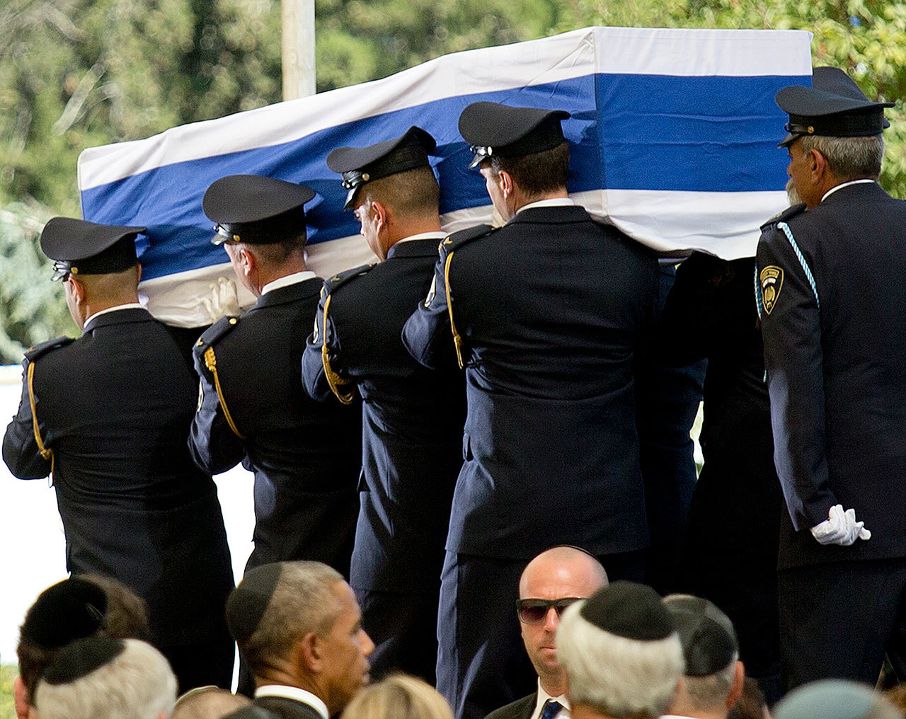 President Barack Obama watches as guards carry the flag-draped coffin towards the burial site during the funeral of former Israeli President Shimon Peres at the Mount Herzel national cemetery in Jerusalemon Friday. (AP Photo/Ariel Schalit)
