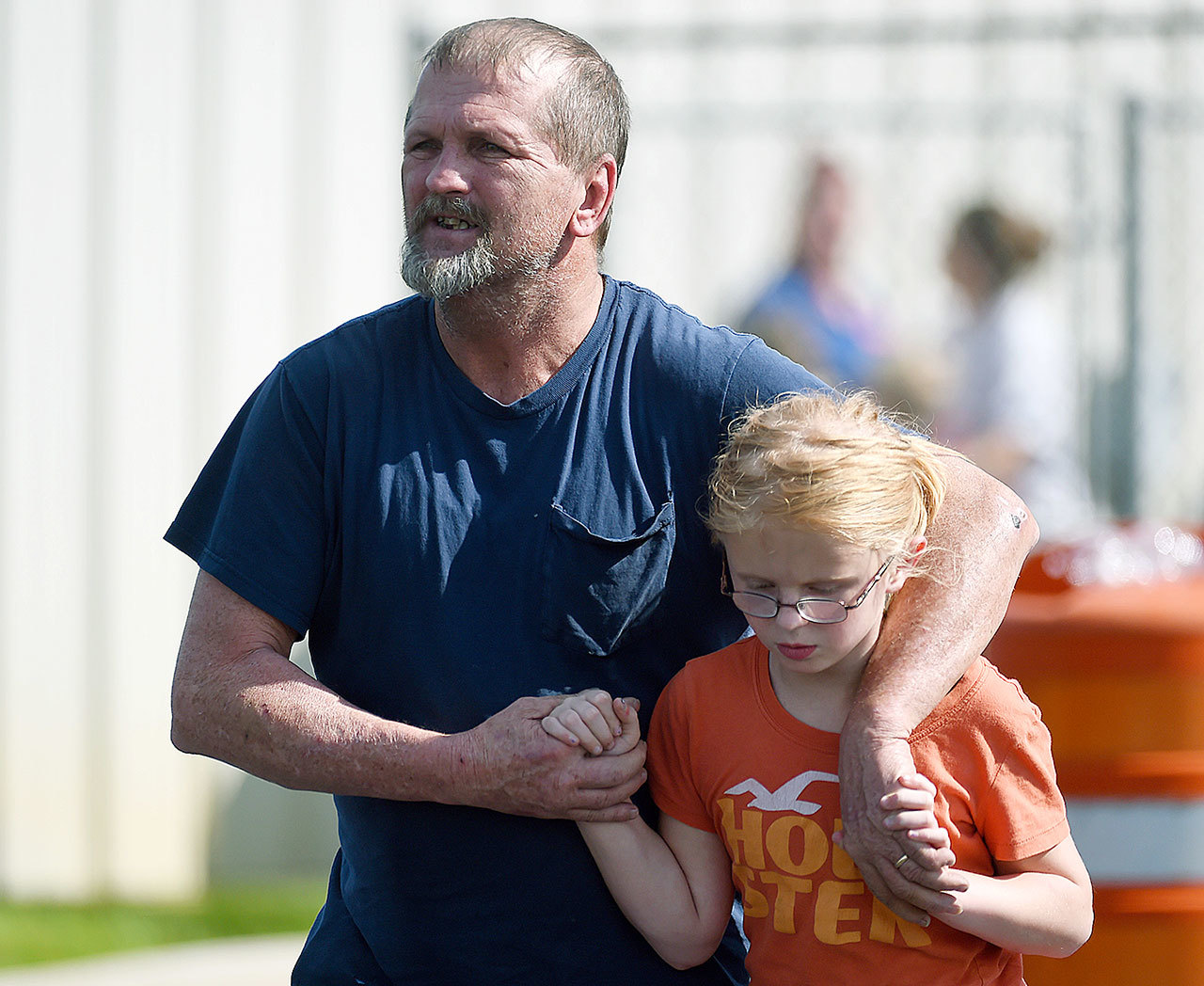 Joey Taylor walks with his daughter Josie Taylor after picking her up at Oakdale Baptist Church on Wednesday in Townville, South Carolina. (AP Photo/Rainier Ehrhardt)