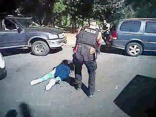 This image made from video shows Keith Scott on the ground as police approach him in Charlotte, North Carolina, on Sept. 20. (Charlotte-Mecklenburg Police Department via AP)