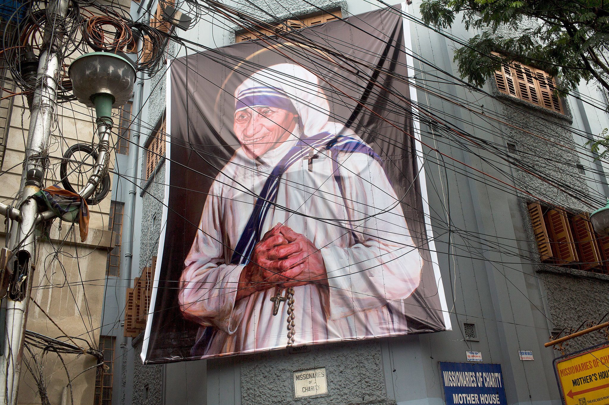 A giant picture of Mother Teresa is displayed outside the Missionaries of Charity mother house in Kolkata, India, on Saturday. (AP Photo/Bernat Armangue)