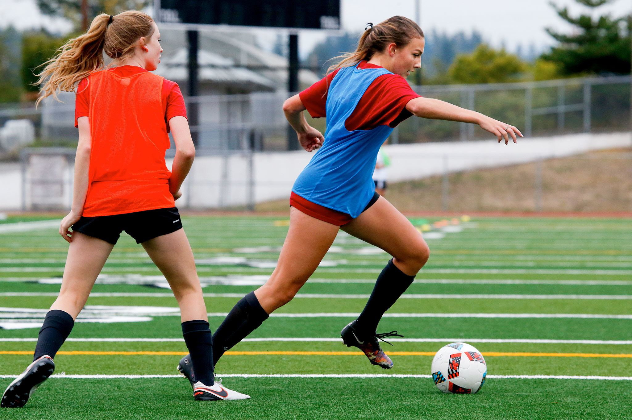 Snohomish midfielder Anna Montemor (right) dribbles past a teammate during practice on Sept. 5. (Andy Bronson / The Herald)