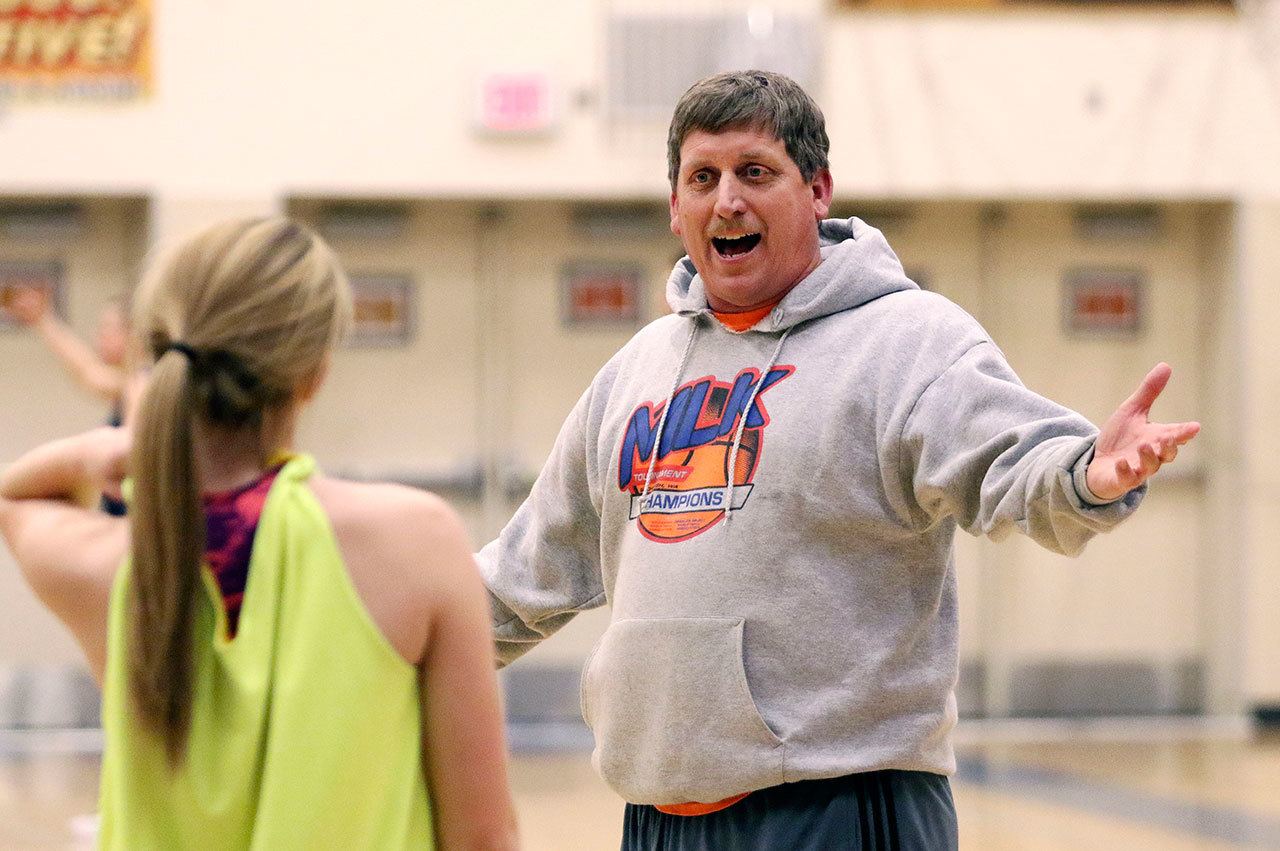 Glacier Peak High School junior-varsity girls basketball coach Jon Rasmussen smiles as he interacts with Haley Grambo during practice in January 2016. (Andy Bronson/ The Herald)