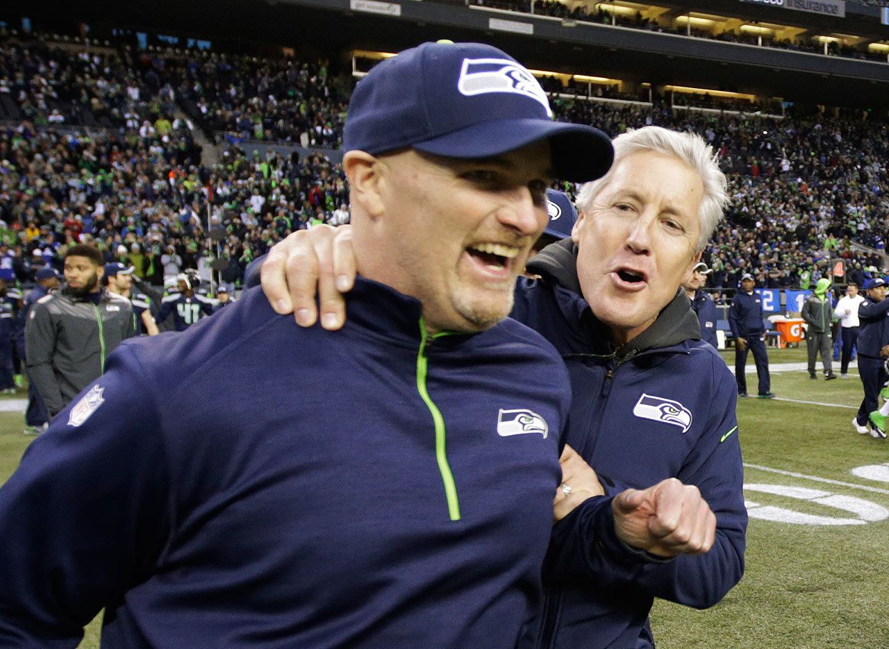 Seahawks head coach Pete Carroll (right) celebrates with defensive coordinator Dan Quinn, now the Falcons head coach, after defeating the Rams on Dec. 28, 2014, in Seattle. (AP Photo/Scott Eklund)