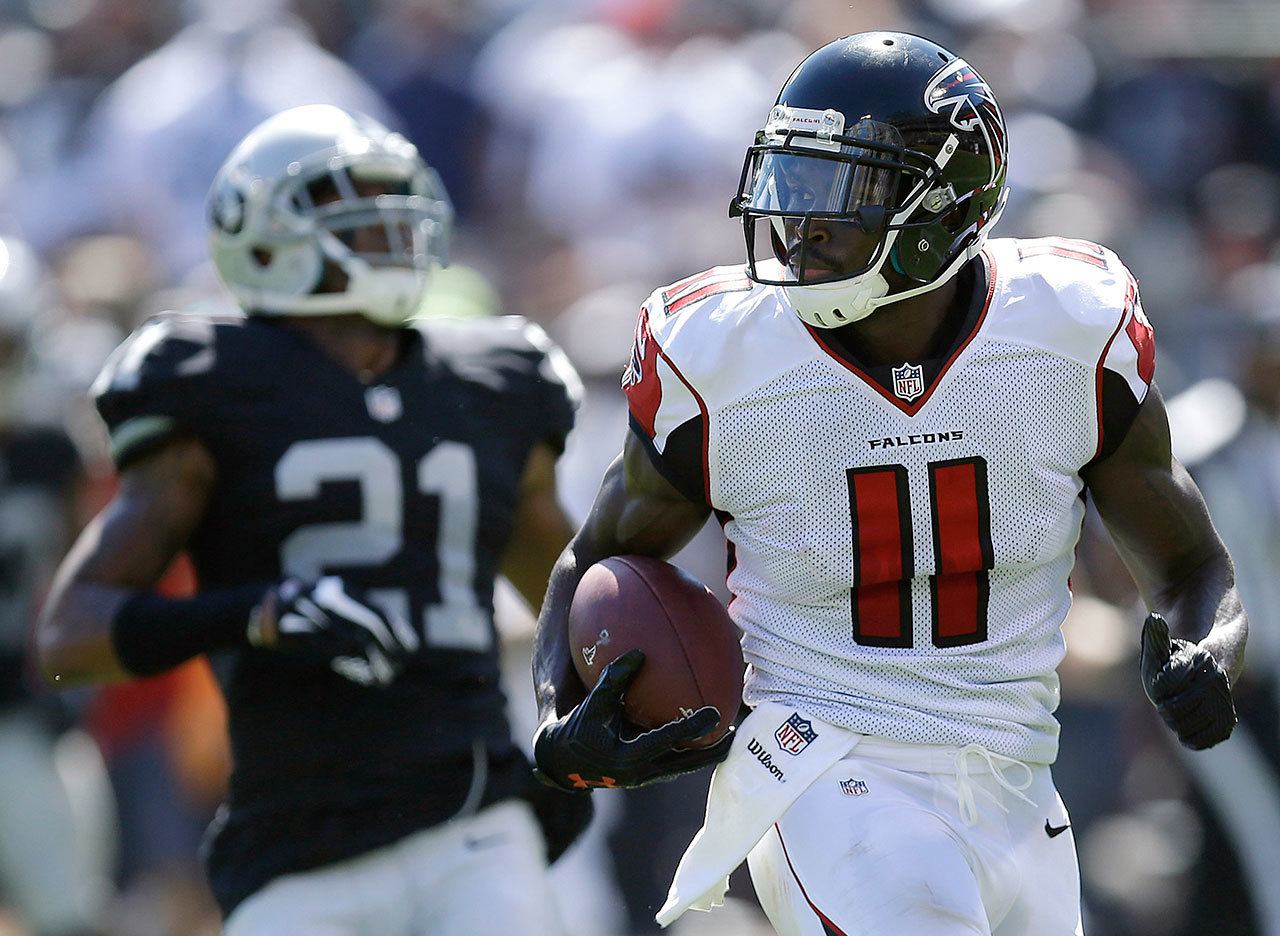 Falcons wide receiver Julio Jones (11) runs past Raiders cornerback Sean Smith (21) to score on a touchdown during a game Sept. 18 in Oakland, Calif. (AP Photo/Ben Margot)