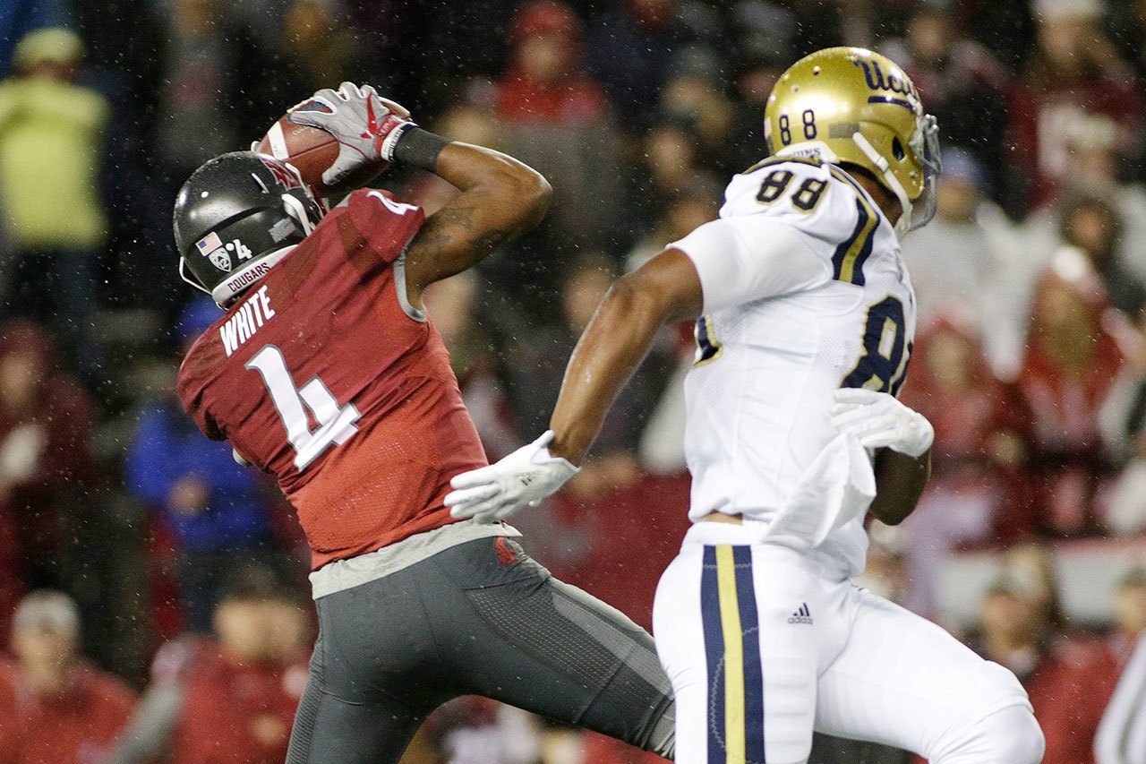 Washington State safety Charleston White (4) intercepts a pass intended for UCLA tight end Austin Roberts (88) near the end of a game Saturday in Pullman. Washington State won 27-21. (AP Photo/Young Kwak)