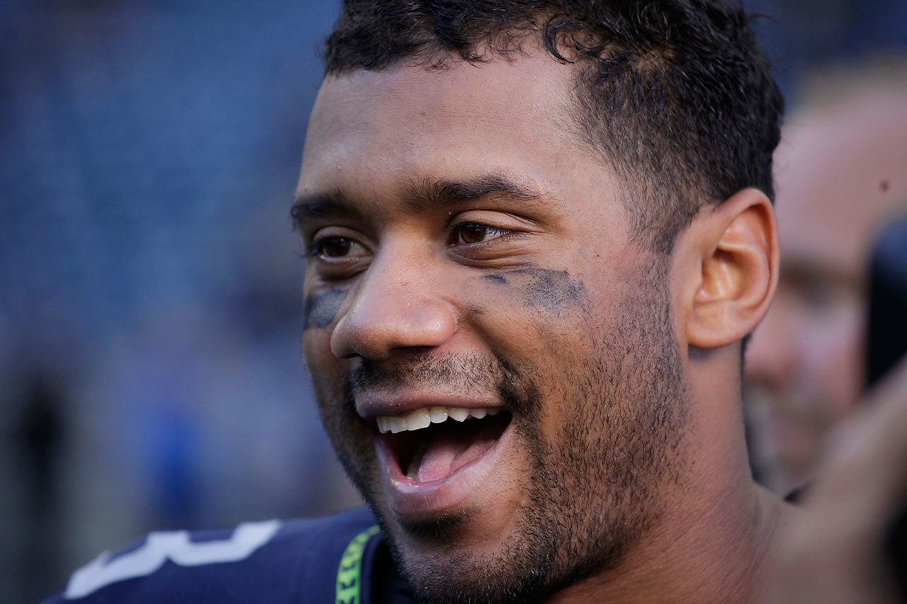 Seahawks quarterback Russell Wilson smiles after a game against the Dolphins on Sept. 11 in Seattle. (AP Photo/Elaine Thompson)