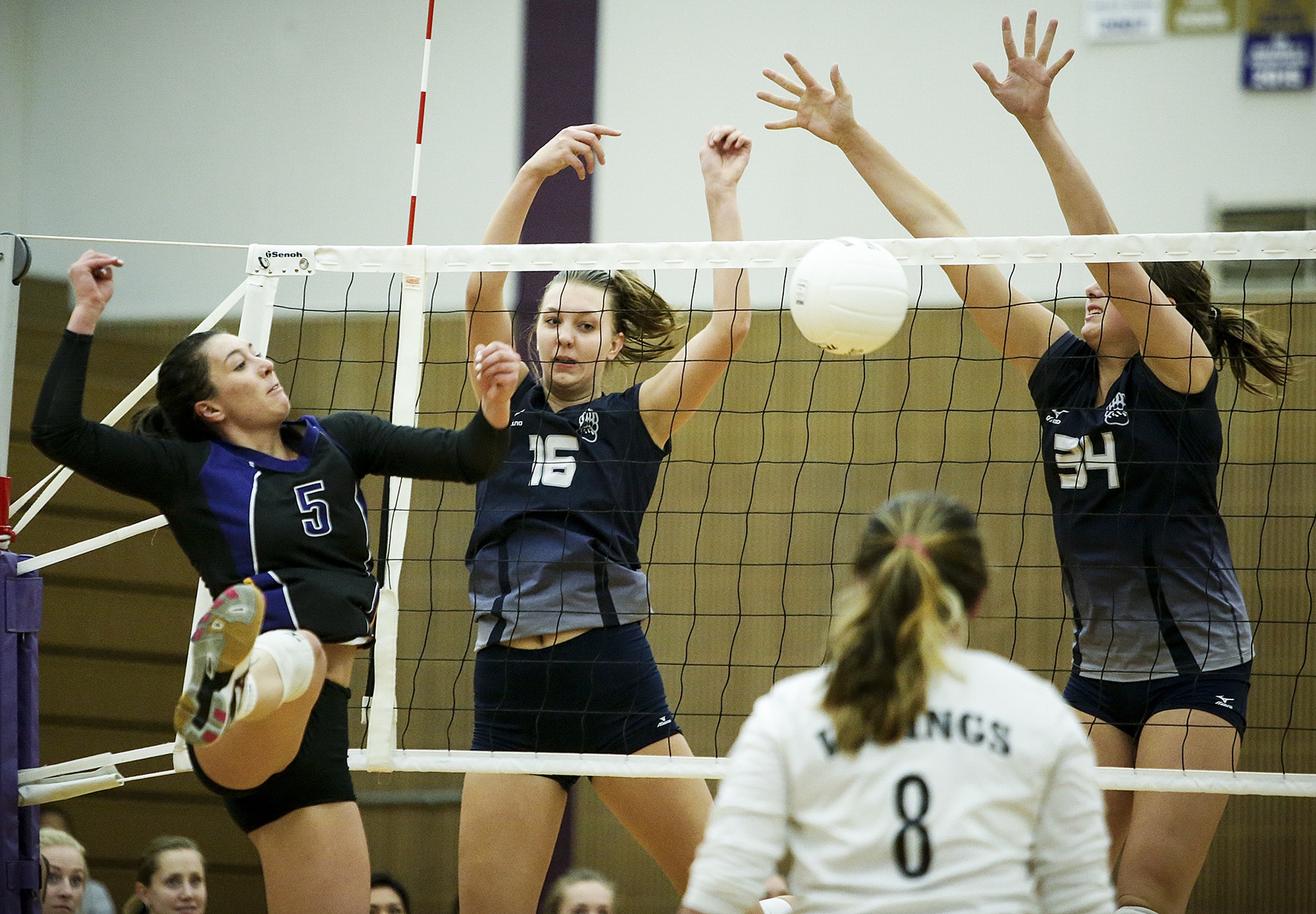 Lake Stevens’ Gabby Gunterman (5) leaps up as Glacier Peak’s Lauren Sanders (16) and Sydney Petersen (34) make a block attempt during a game at Lake Stevens High School on Tuesday, Oct. 18. (Ian Terry / The Herald)