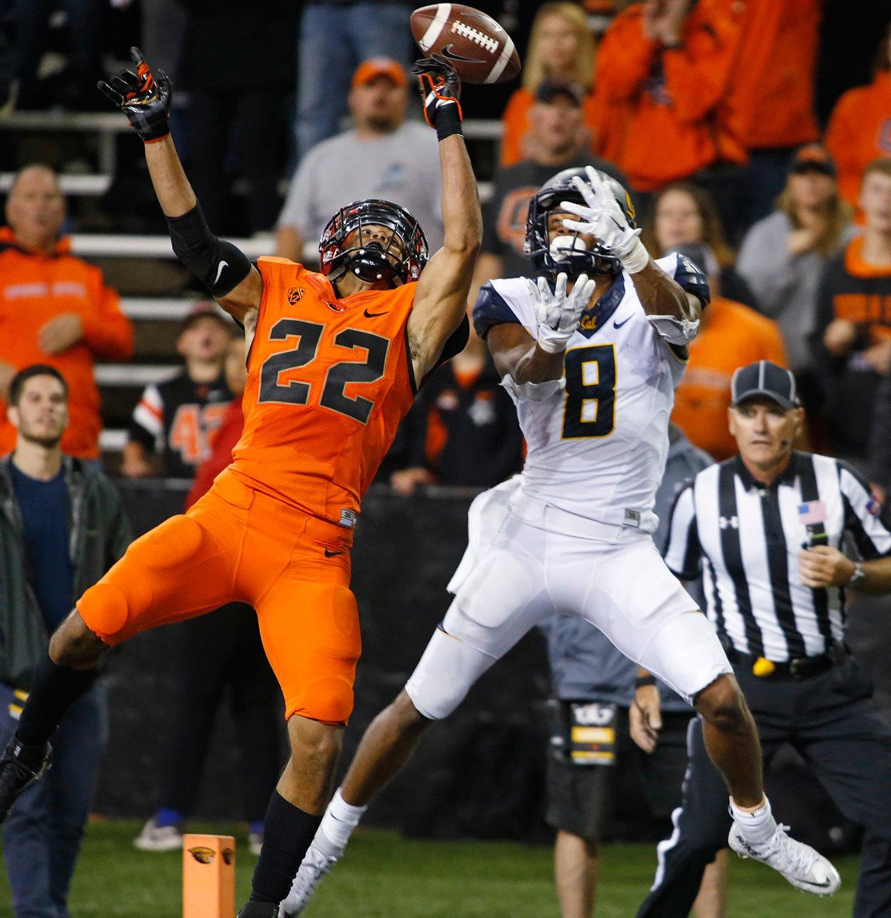 Oregon State cornerback Xavier Crawford (22) breaks up a pass intended for California’s Demetrius Robertson during the second half of a game Oct. 8 in Corvallis, Ore. (AP Photo/Timothy J. Gonzalez)