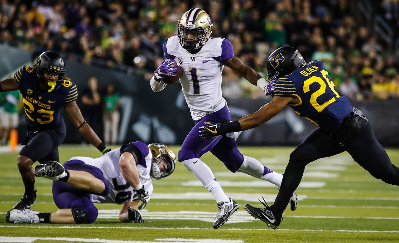 Washington wide receiver John Ross (1) gets past Oregon defensive back Khalil Oliver (26) during a game Oct. 8 in Eugene, Ore. Washington won 70-21. (AP Photo/Thomas Boyd)