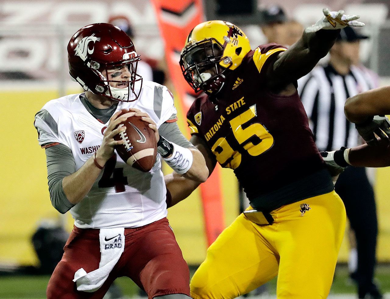 Washington State quarterback Luke Falk (4) looks to throw under pressure from Arizona State defensive lineman Renell Wren (95) during the first half of a game Saturday in Tempe, Ariz. (AP Photo/Matt York)